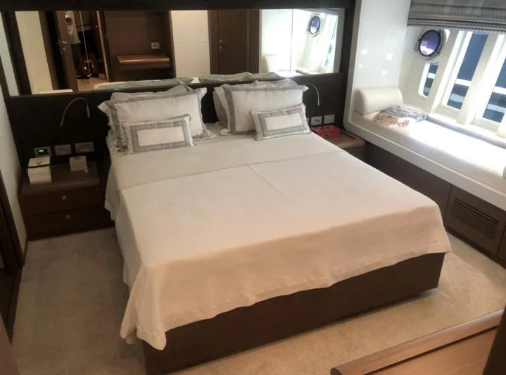a bed with a white sheet aboard FERRETTI F800/27 Yacht for Sale