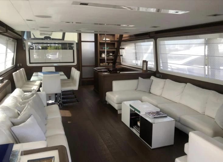 a room with couches and a table aboard FERRETTI F800/27 Yacht for Sale