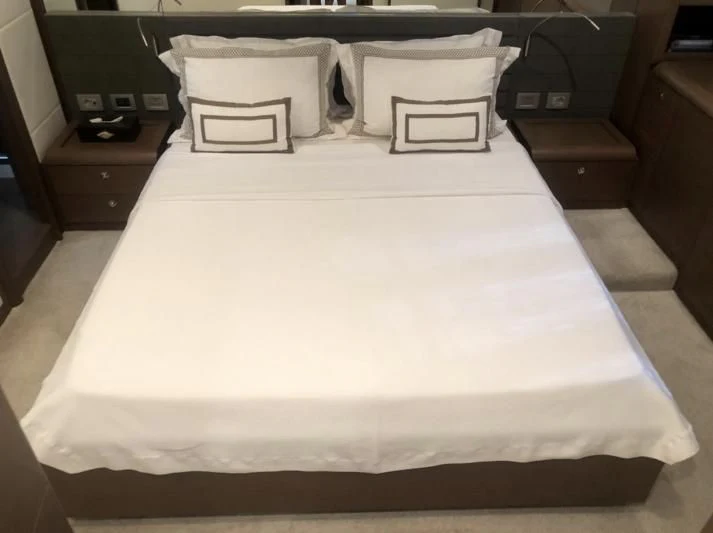 a bed with white sheets aboard FERRETTI F800/27 Yacht for Sale