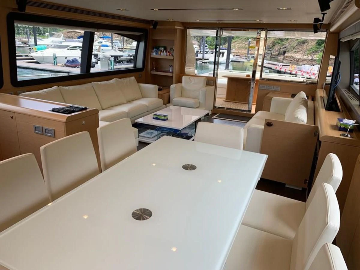 a room with a table and chairs aboard FERRETTI F800/27 Yacht for Sale
