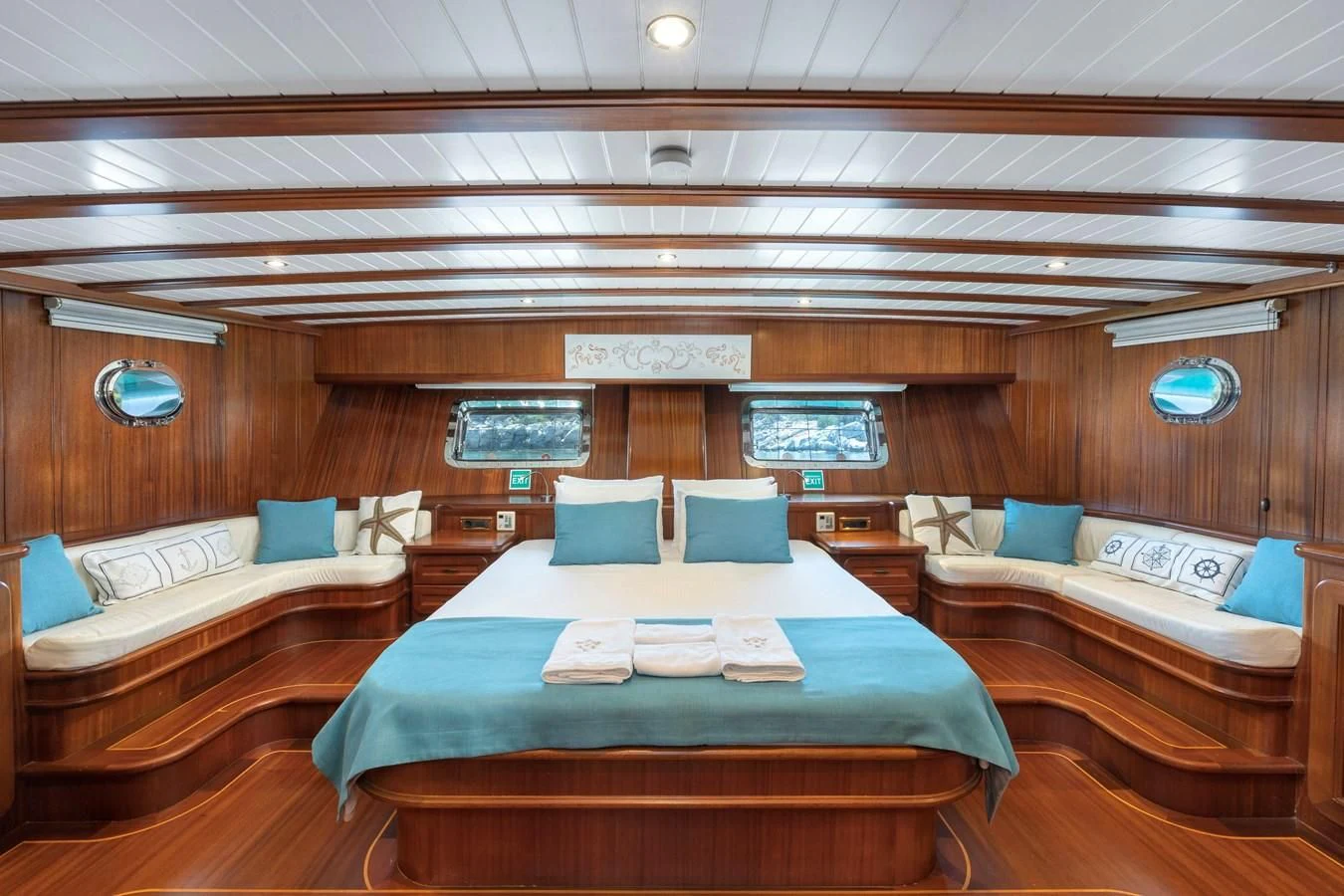 a room with beds and a table aboard L'ORIENT Yacht for Sale