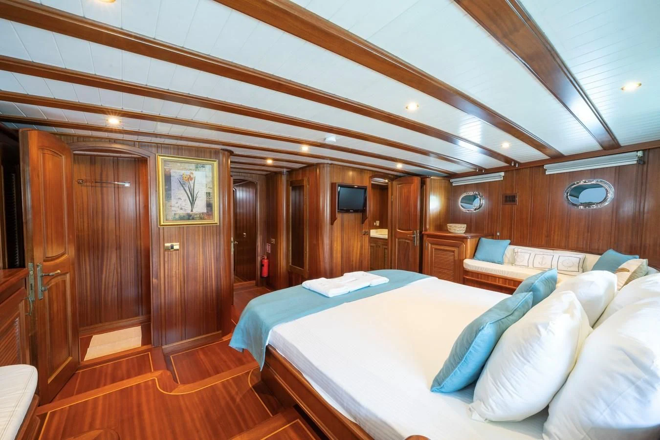 a room with a bed and a wood door aboard L'ORIENT Yacht for Sale