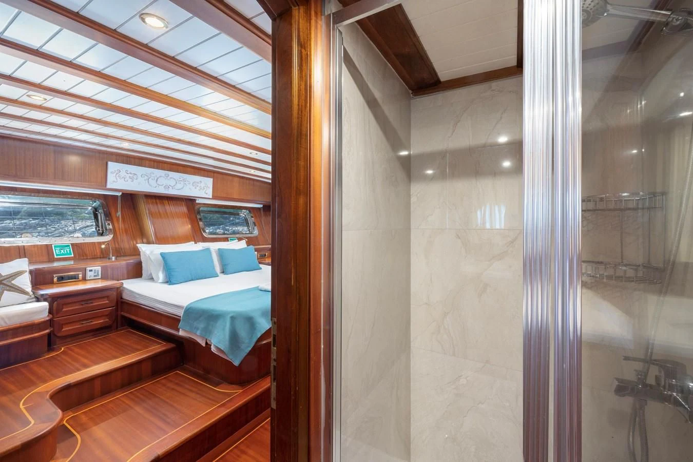 a room with a bed and a glass door aboard L'ORIENT Yacht for Sale