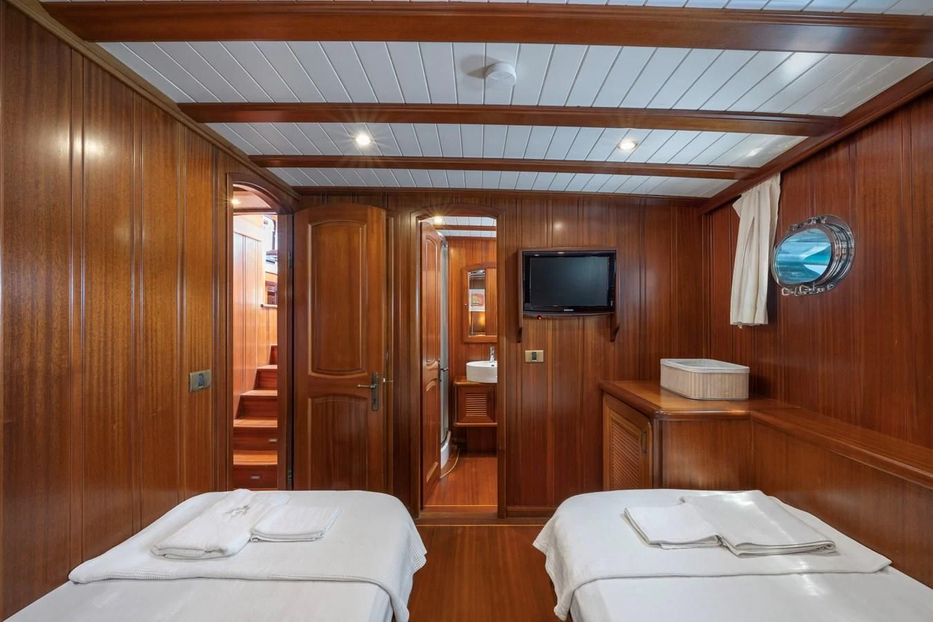 a room with a bed and a television aboard L'ORIENT Yacht for Sale