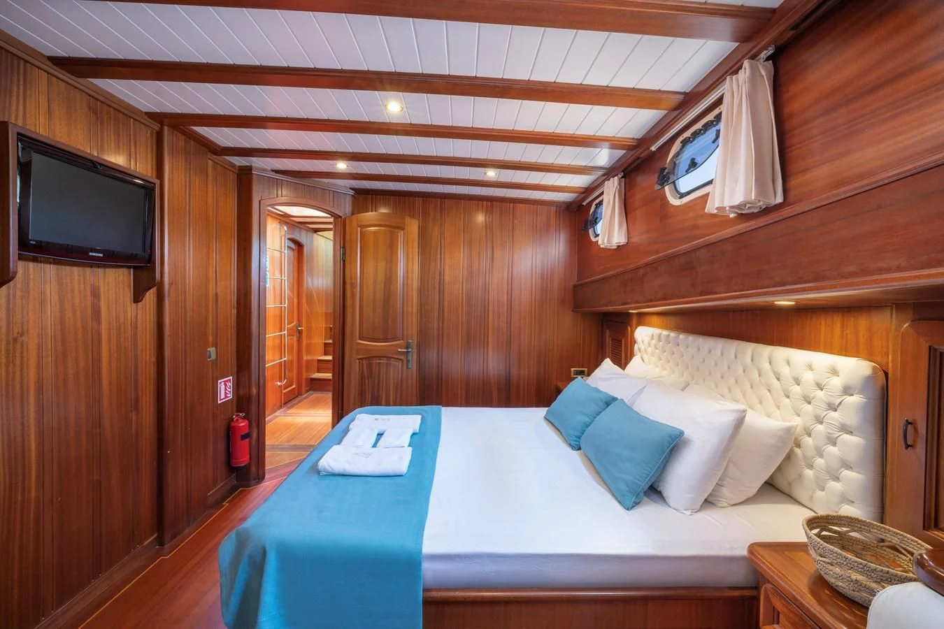a room with a bed and a television aboard L'ORIENT Yacht for Sale