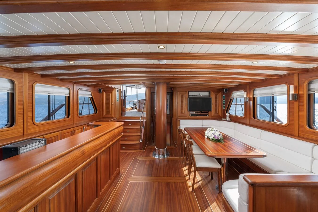 a room with wooden floors and wooden walls aboard L'ORIENT Yacht for Sale