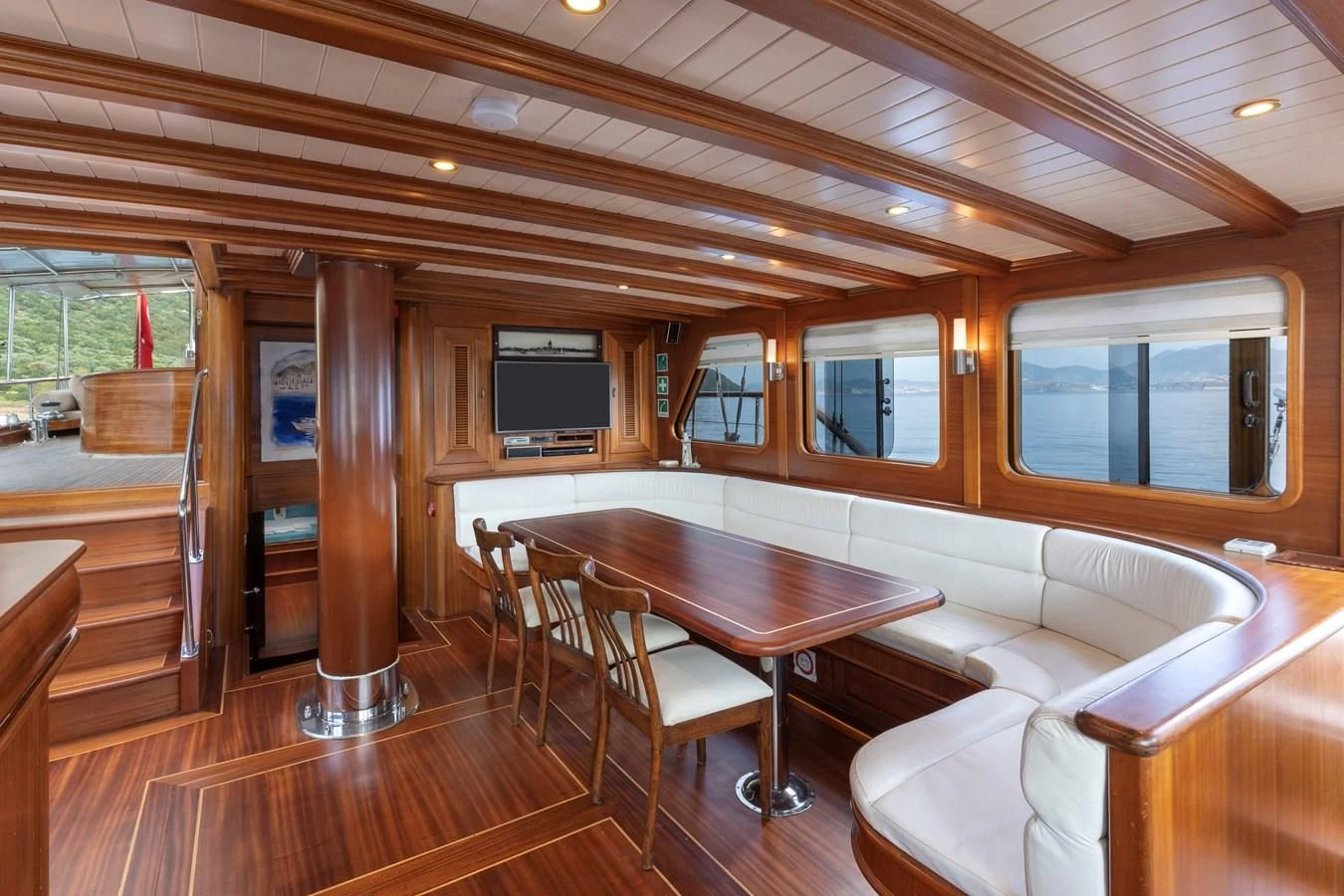 a room with a table and chairs aboard L'ORIENT Yacht for Sale