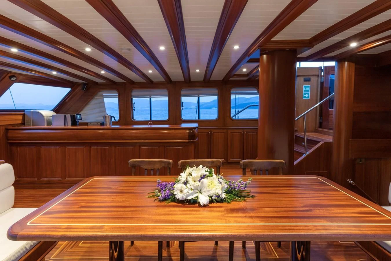 a room with a table and chairs aboard L'ORIENT Yacht for Sale