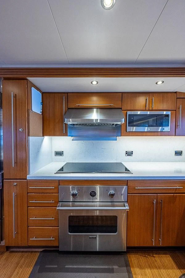a kitchen with a stove and microwave aboard SUPERSTAR Yacht for Charter