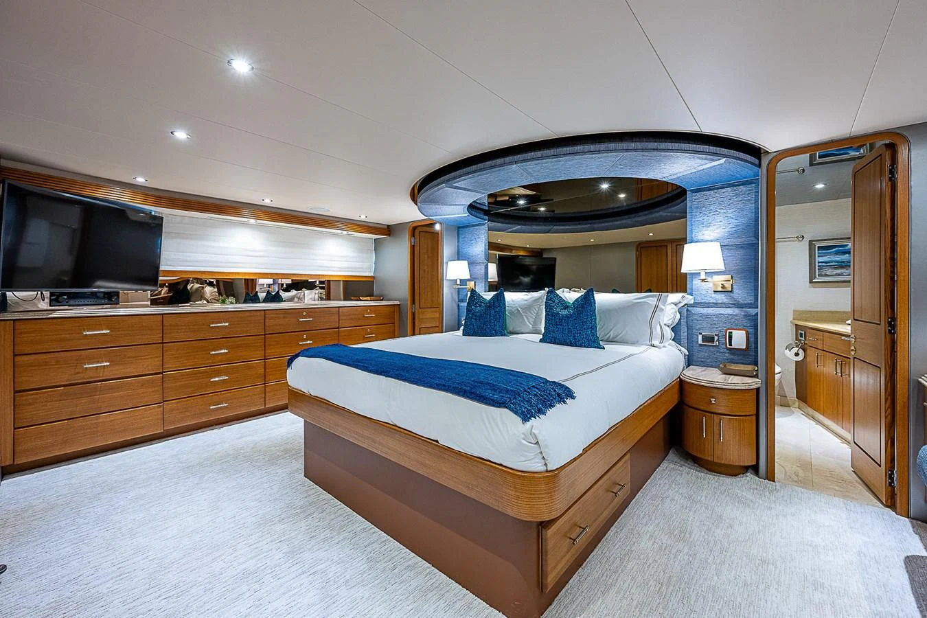 a bedroom with a bed and a television aboard SUPERSTAR Yacht for Charter
