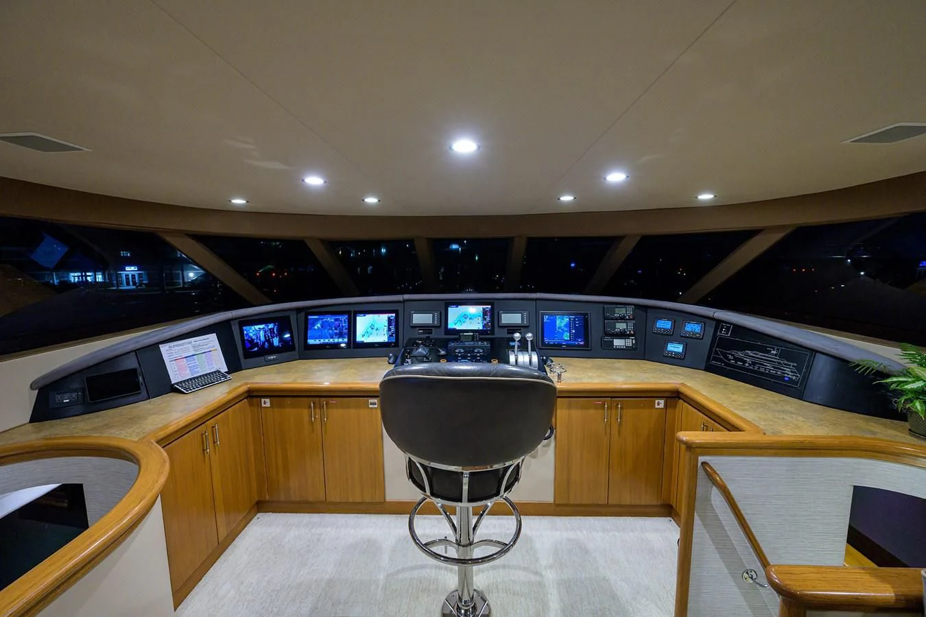 a room with a large desk and chairs and a large computer screen aboard SUPERSTAR Yacht for Charter