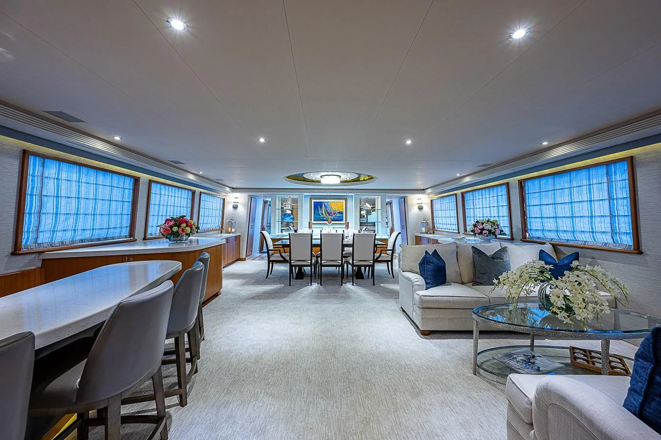 a large living room with a large table and chairs aboard SUPERSTAR Yacht for Charter