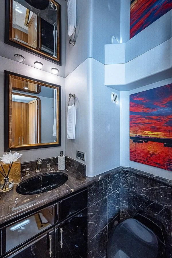 a bathroom with a sink and a mirror aboard SUPERSTAR Yacht for Charter