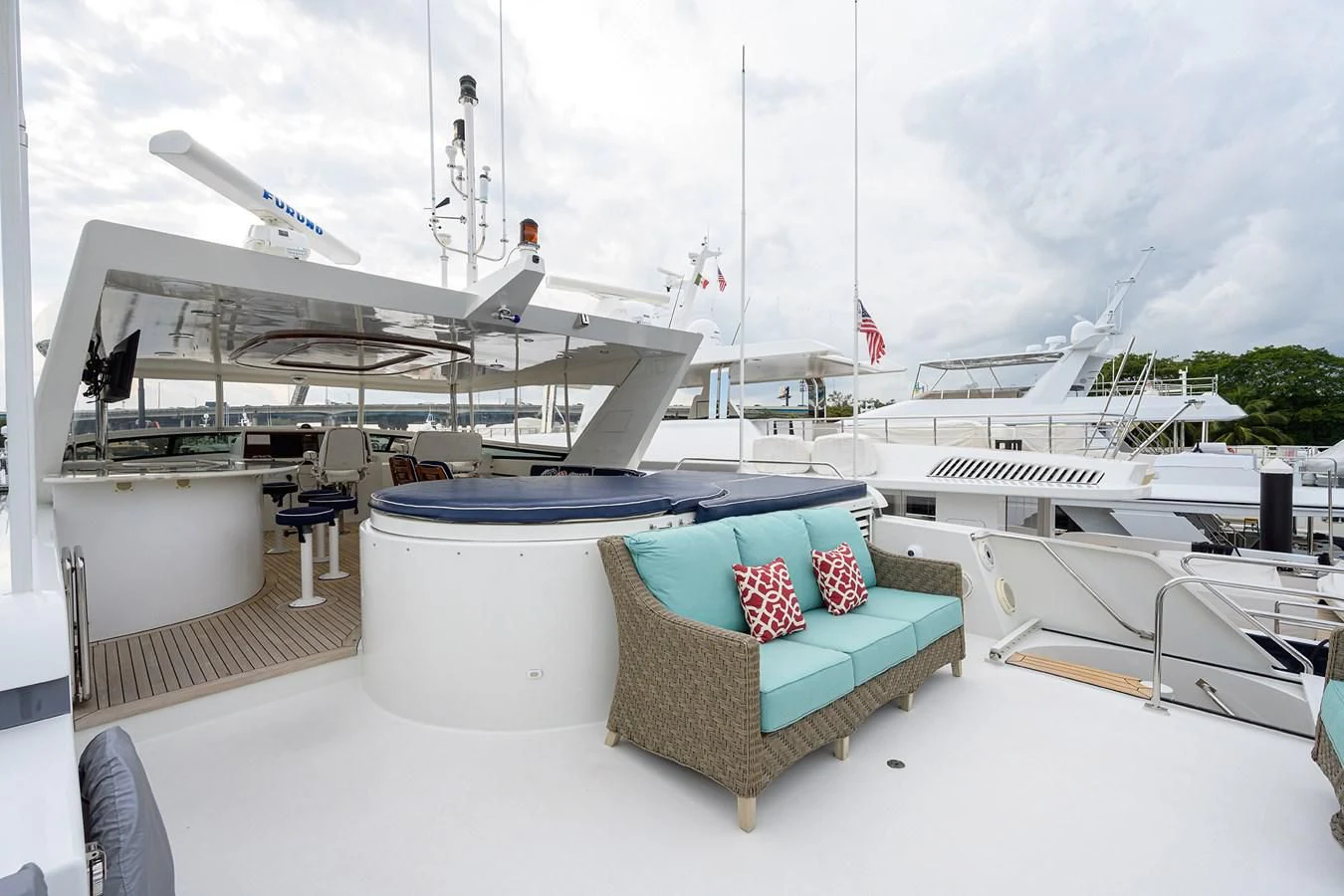 a deck with a chair and a boat on it aboard SUPERSTAR Yacht for Charter