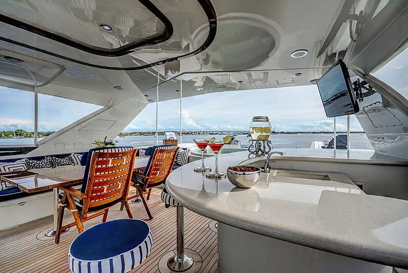 inside of a ship with tables and chairs and a computer monitor aboard SUPERSTAR Yacht for Charter