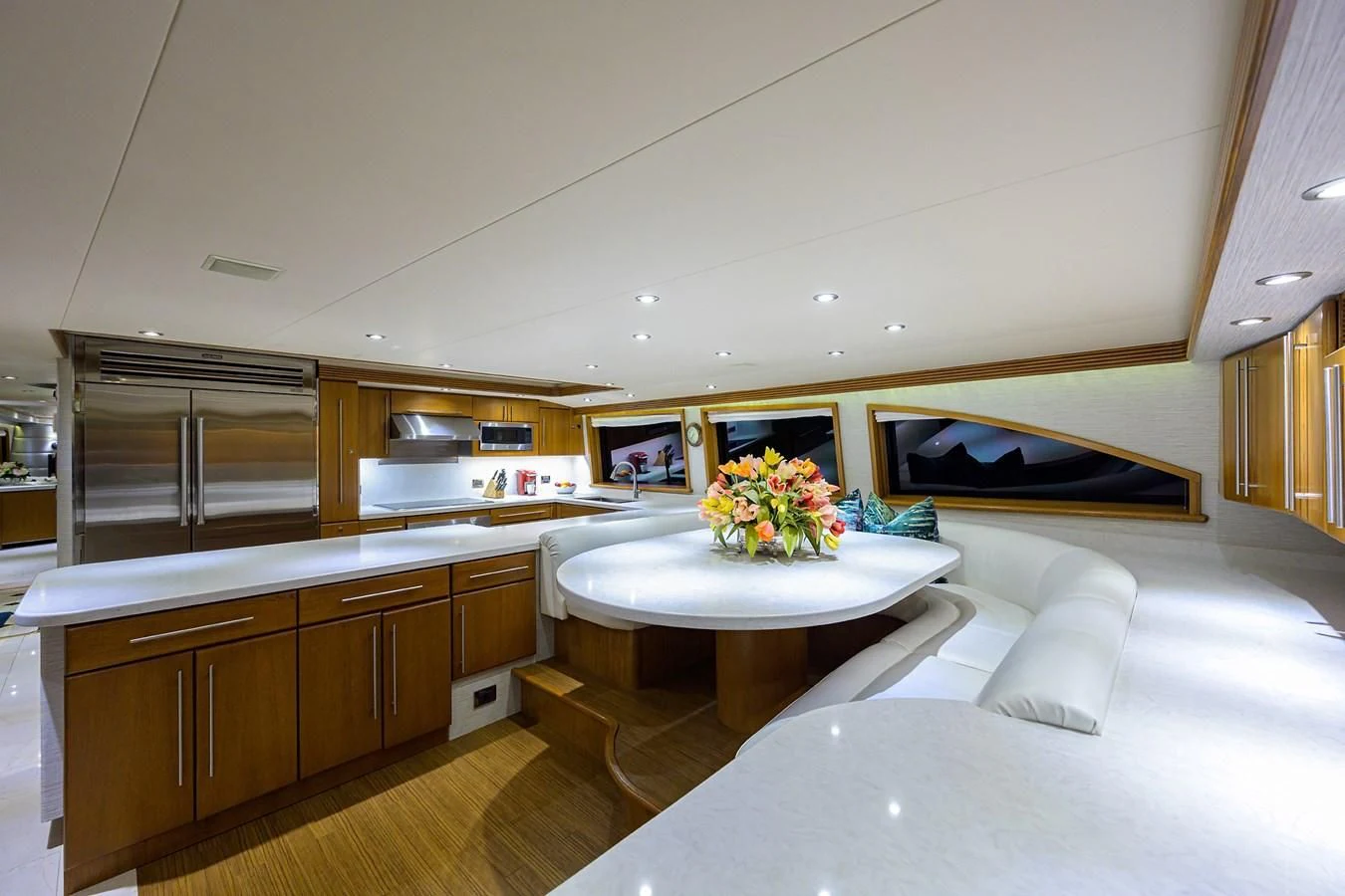 a modern looking bedroom with a large white table and a large window aboard SUPERSTAR Yacht for Charter
