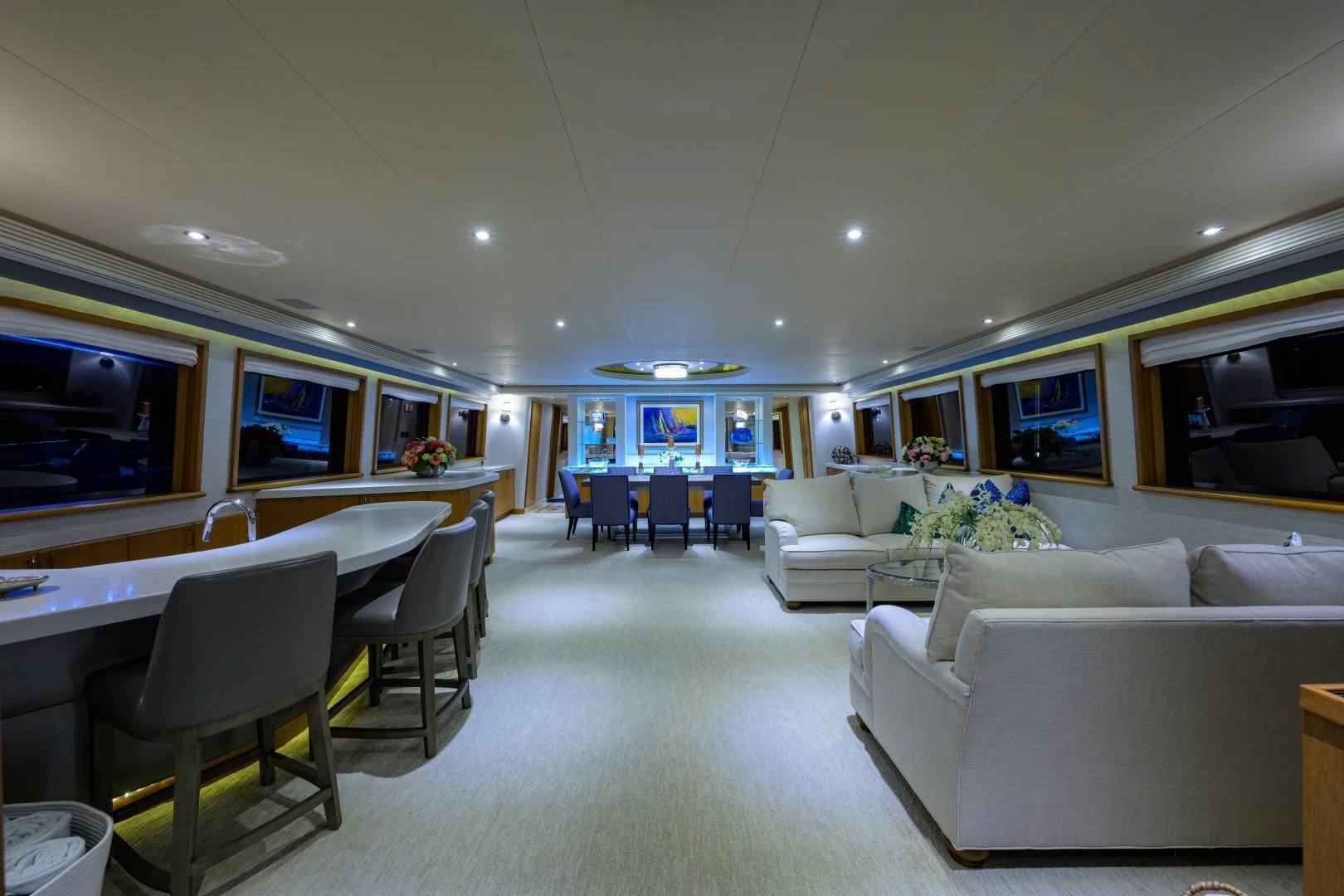 a large living room with a white couch and a large table aboard SUPERSTAR Yacht for Charter