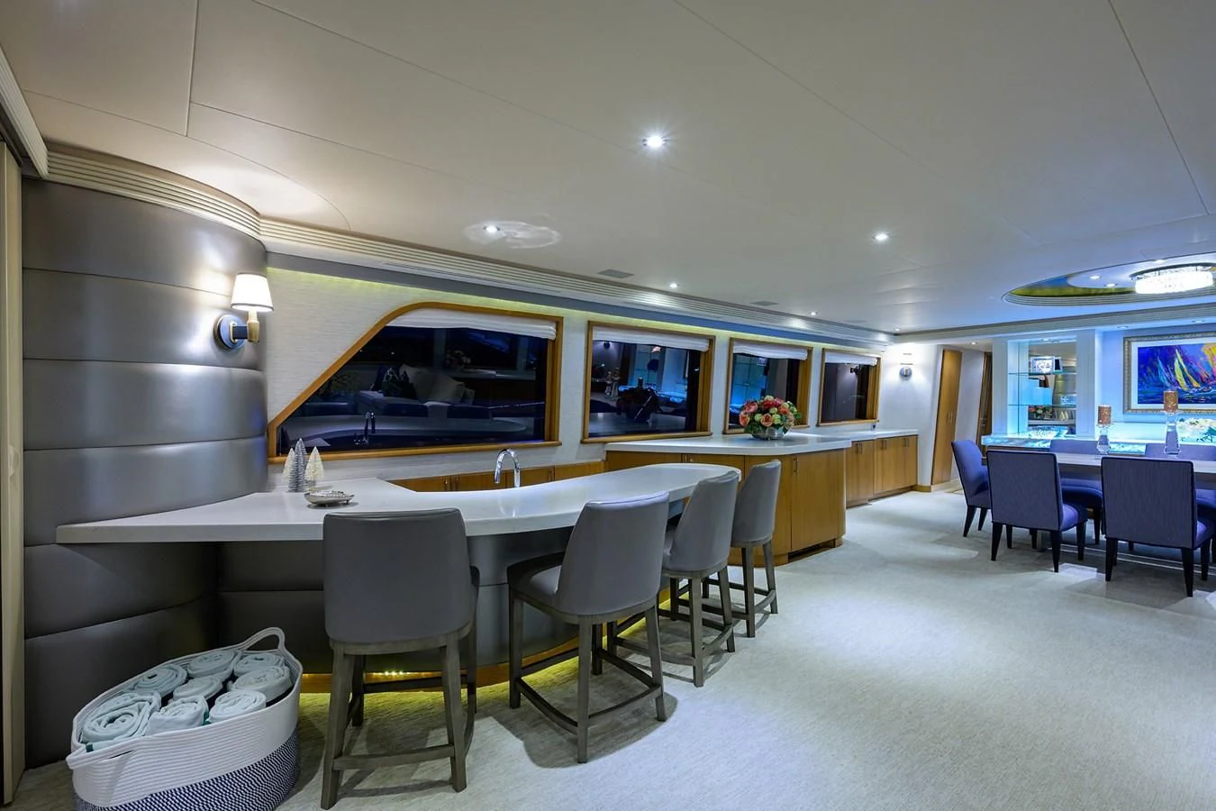 a room with tables and chairs aboard SUPERSTAR Yacht for Charter