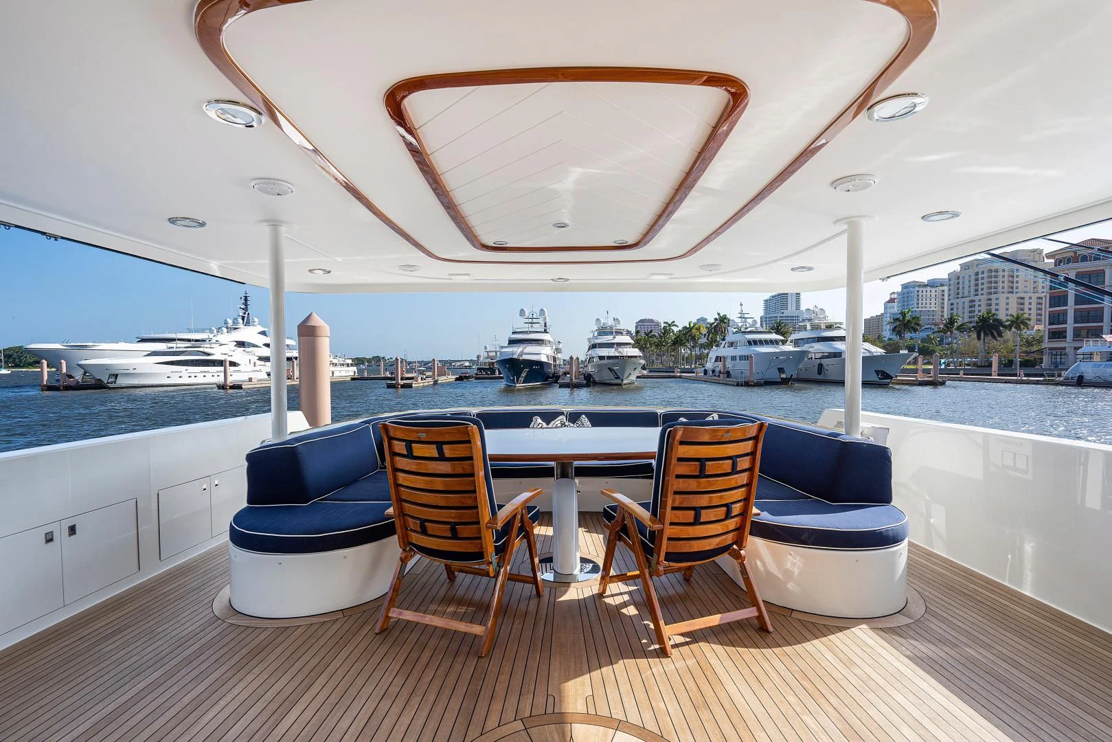 a deck with chairs and a table on it aboard SUPERSTAR Yacht for Charter