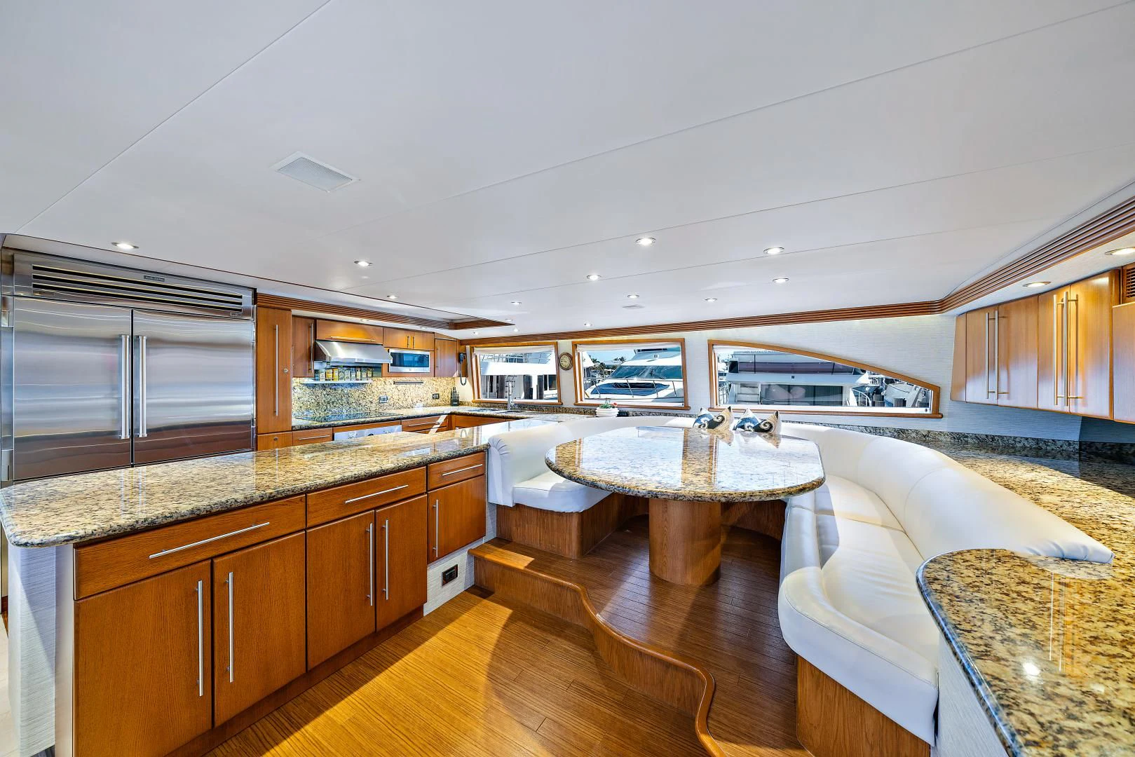 a kitchen with a table and couch aboard SUPERSTAR Yacht for Charter