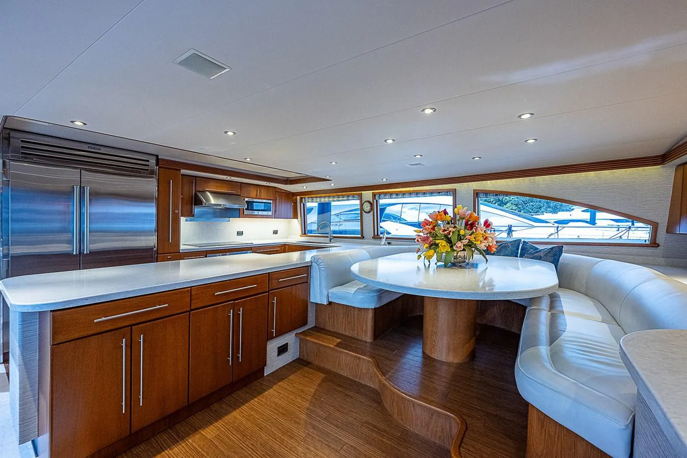 a kitchen with a table and a couch aboard SUPERSTAR Yacht for Charter