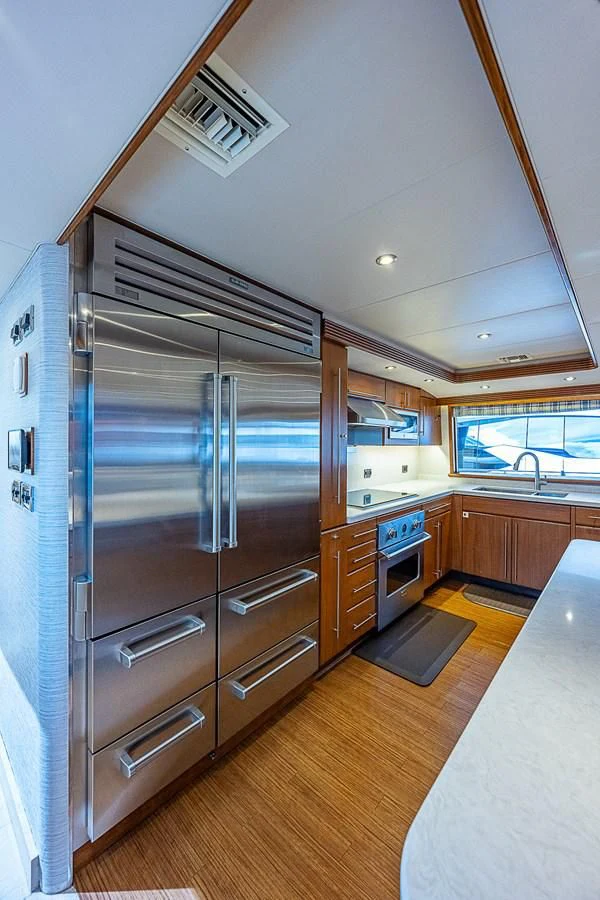 a kitchen with a stainless steel refrigerator aboard SUPERSTAR Yacht for Charter