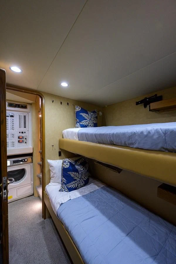 a small bedroom with a bed aboard SUPERSTAR Yacht for Charter