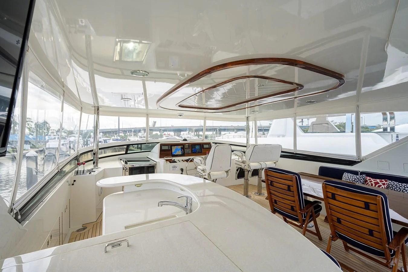 inside of a building with a large white table and chairs and a large fan aboard SUPERSTAR Yacht for Charter