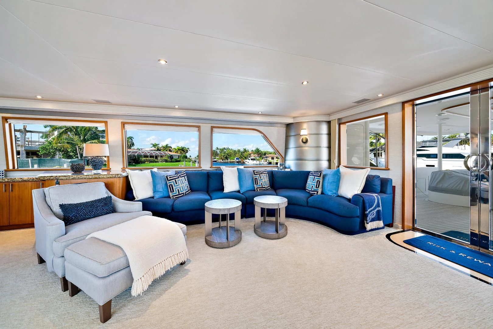a living room with blue couches aboard SUPERSTAR Yacht for Charter