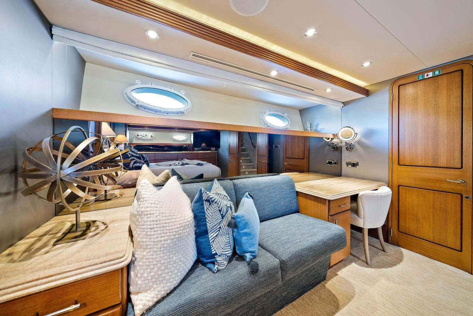 a room with a couch and a table and a fan aboard SUPERSTAR Yacht for Charter