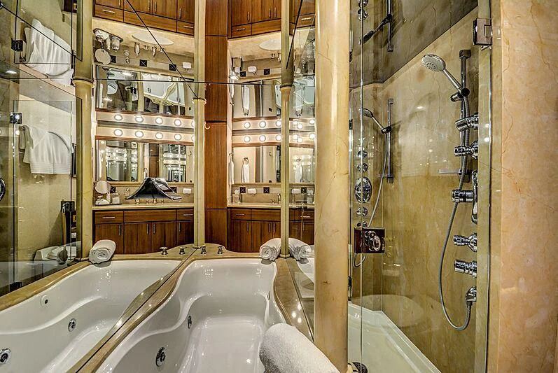 a bathroom with a shower and tub aboard SUPERSTAR Yacht for Charter