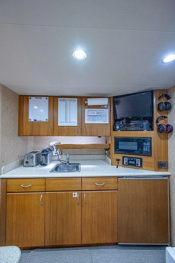 a kitchen with wooden cabinets aboard SUPERSTAR Yacht for Charter