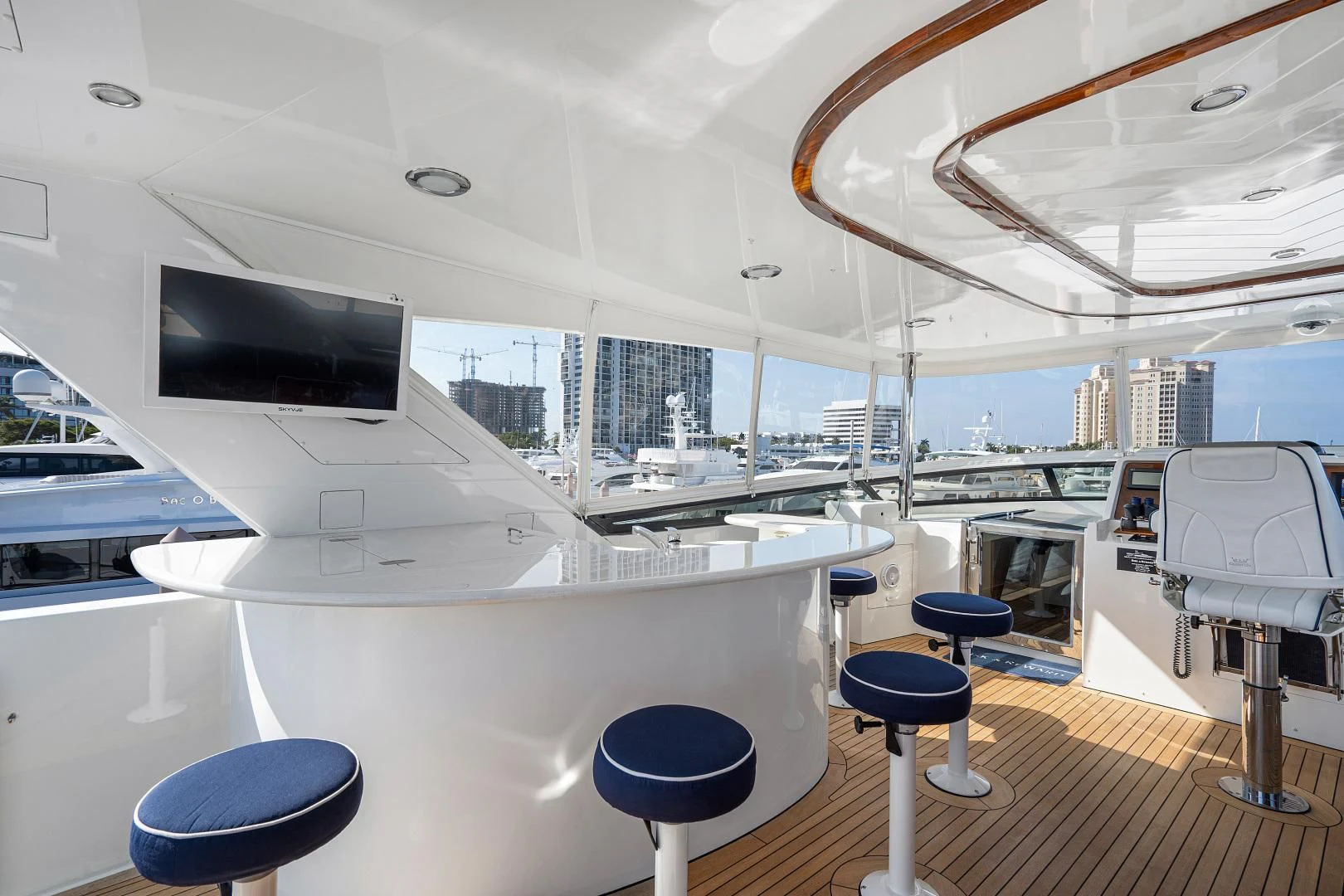 a room with a large window and a table with stools aboard SUPERSTAR Yacht for Charter