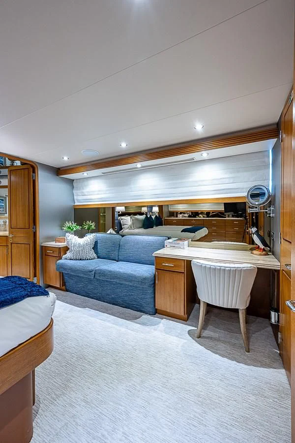 a bedroom with a bed and a desk aboard SUPERSTAR Yacht for Charter