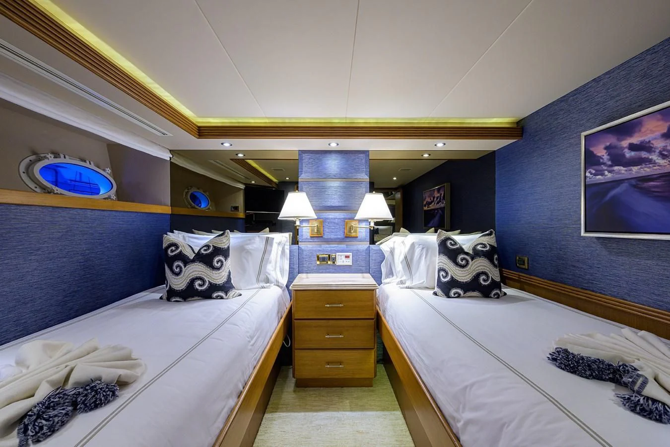 a room with a couple of beds aboard SUPERSTAR Yacht for Charter