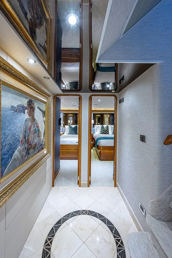 a room with paintings on the wall aboard SUPERSTAR Yacht for Charter