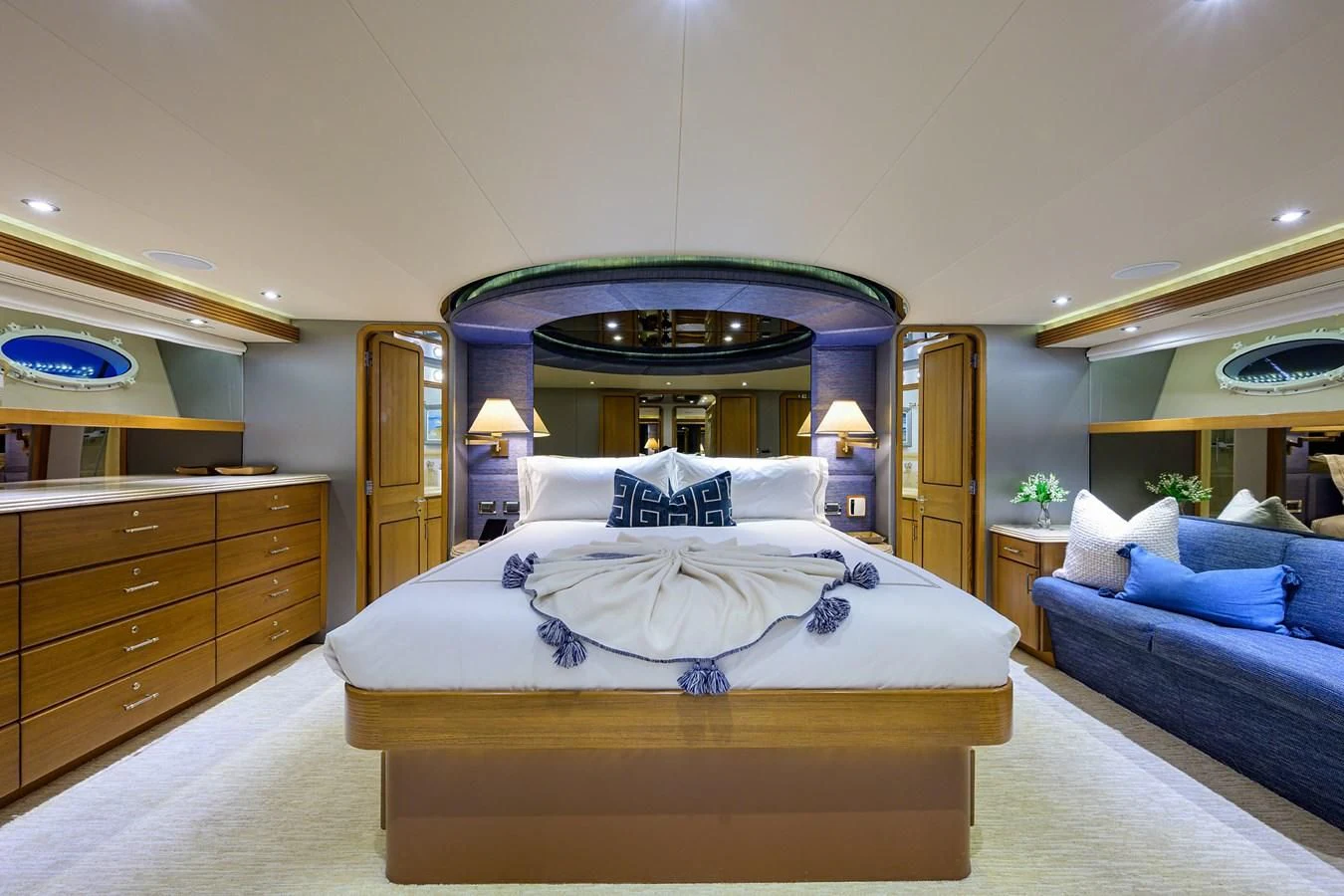 a bedroom with a bed and a dresser aboard SUPERSTAR Yacht for Charter