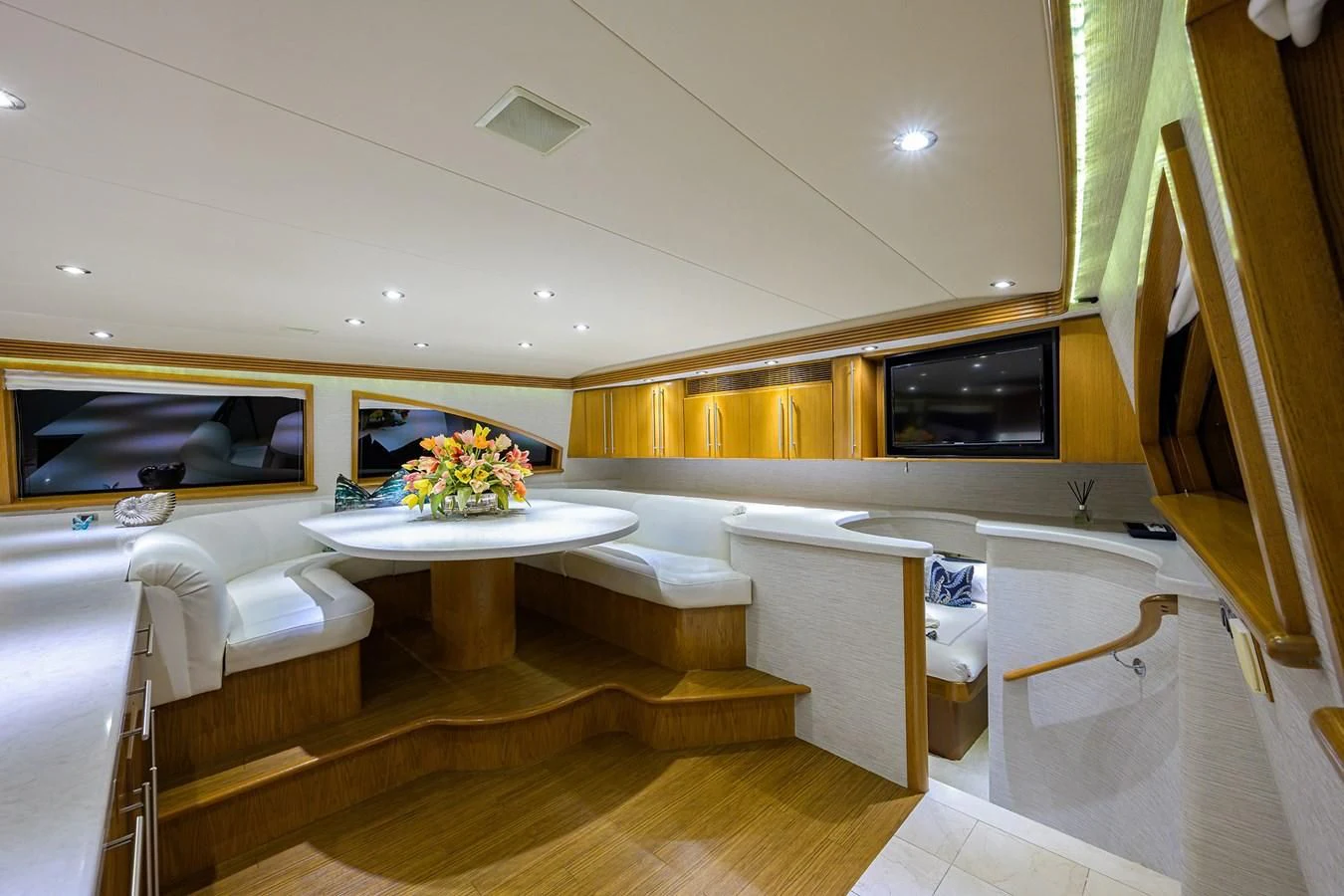 a room with a table and chairs aboard SUPERSTAR Yacht for Charter