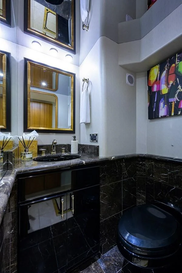 a bathroom with a black tub aboard SUPERSTAR Yacht for Charter