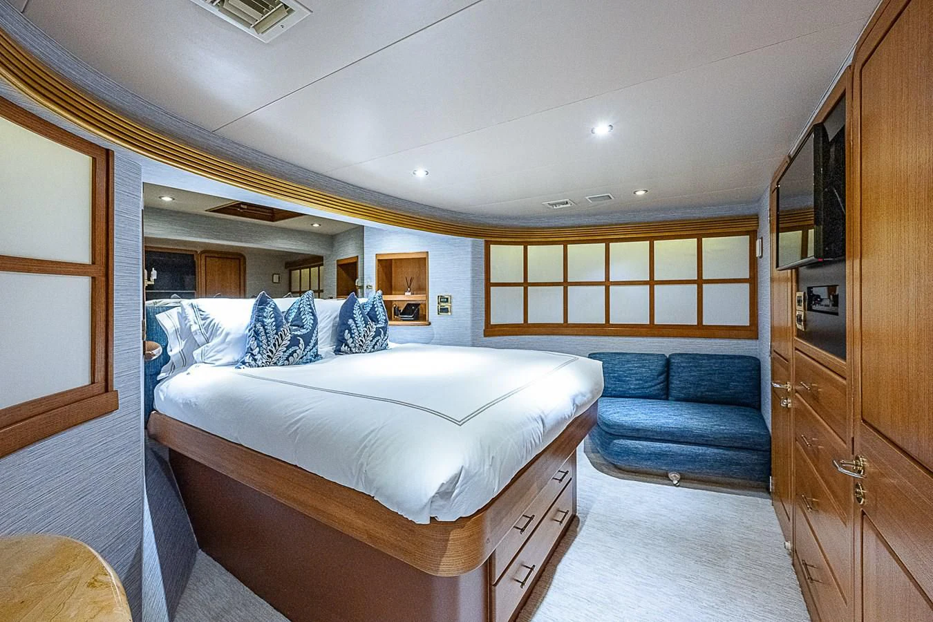 a bedroom with a bed and a couch aboard SUPERSTAR Yacht for Charter