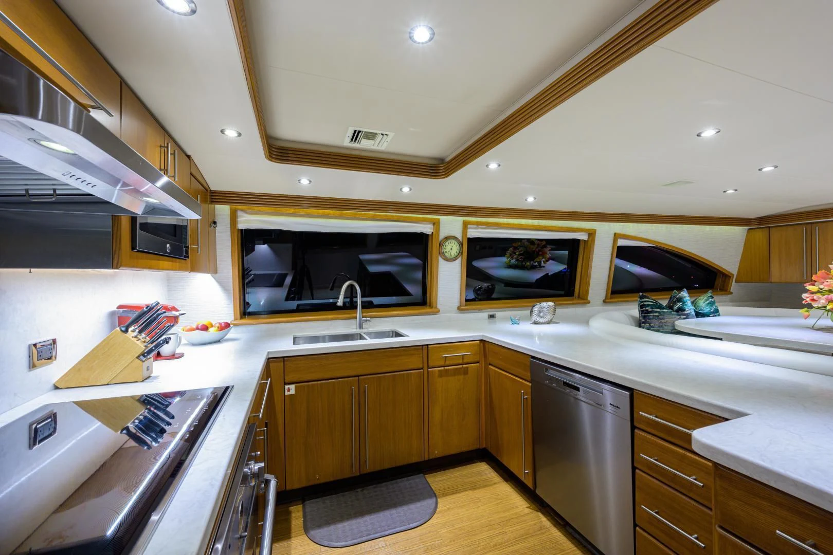 a kitchen with a large flat screen television and wooden cabinets aboard SUPERSTAR Yacht for Charter