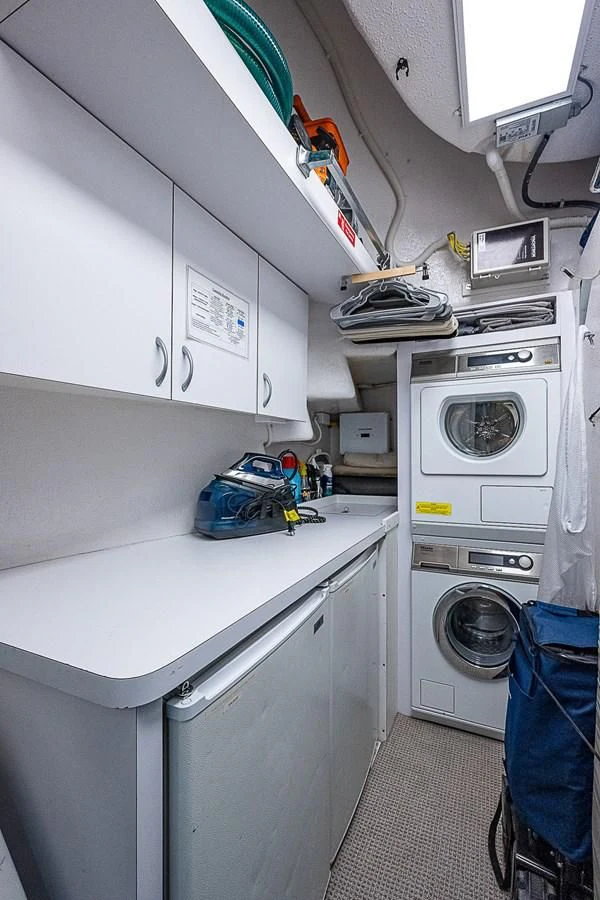 a white laundry room aboard SUPERSTAR Yacht for Charter