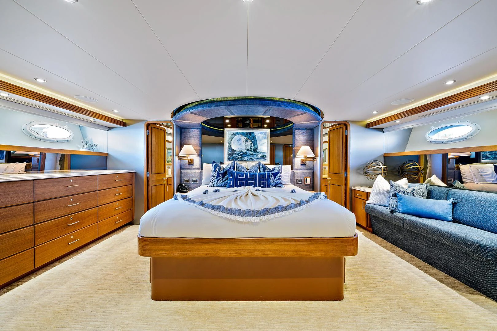 a bedroom with a blue bed aboard SUPERSTAR Yacht for Charter