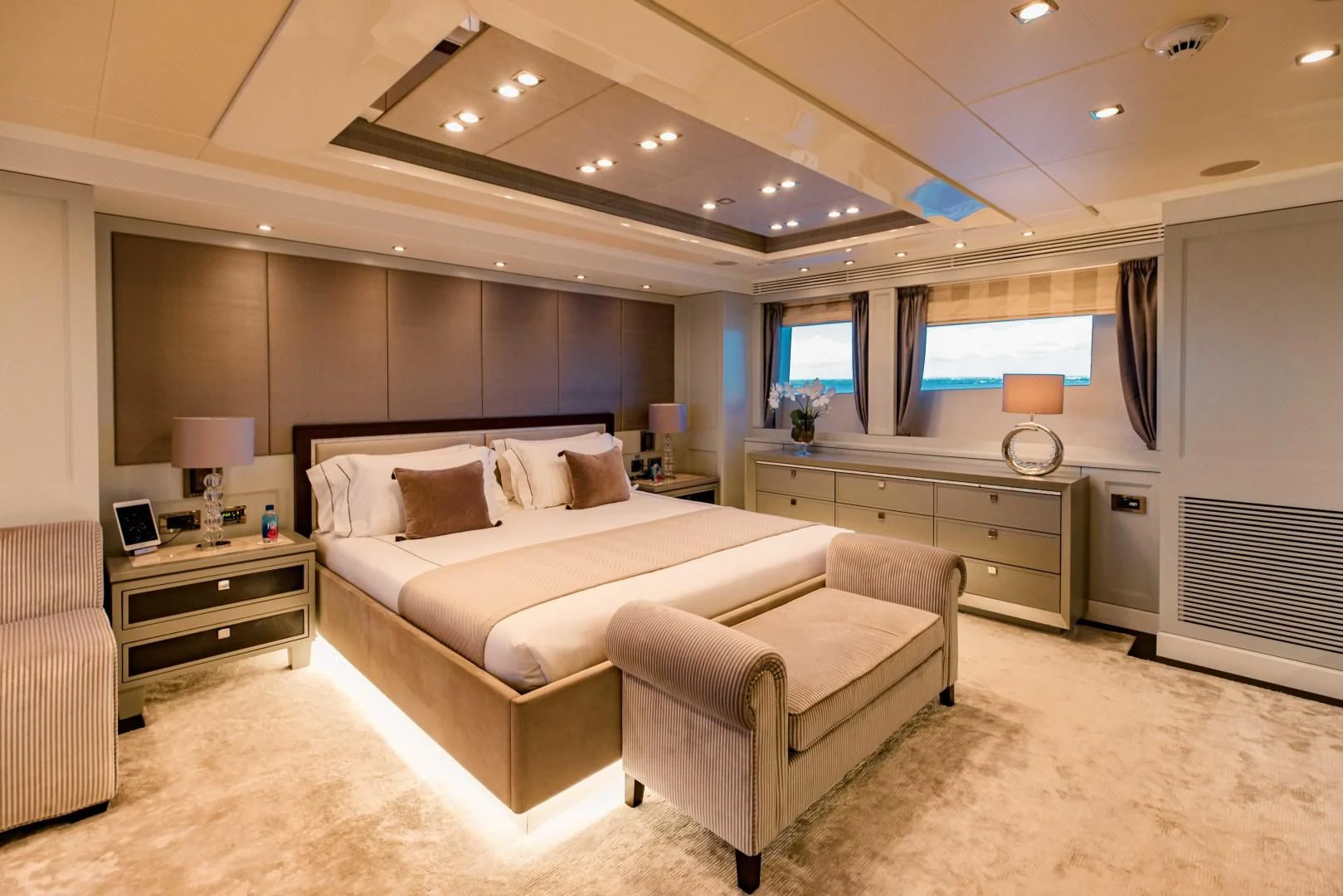 a large bedroom with a bed and a desk aboard TAYRONA Yacht for Sale