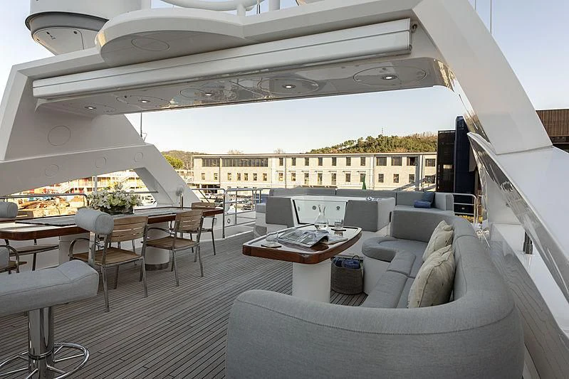 a room with a couch and a table and a large window aboard TAYRONA Yacht for Sale