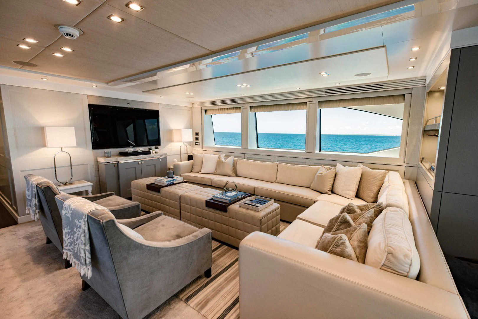 a living room with a large window aboard TAYRONA Yacht for Sale