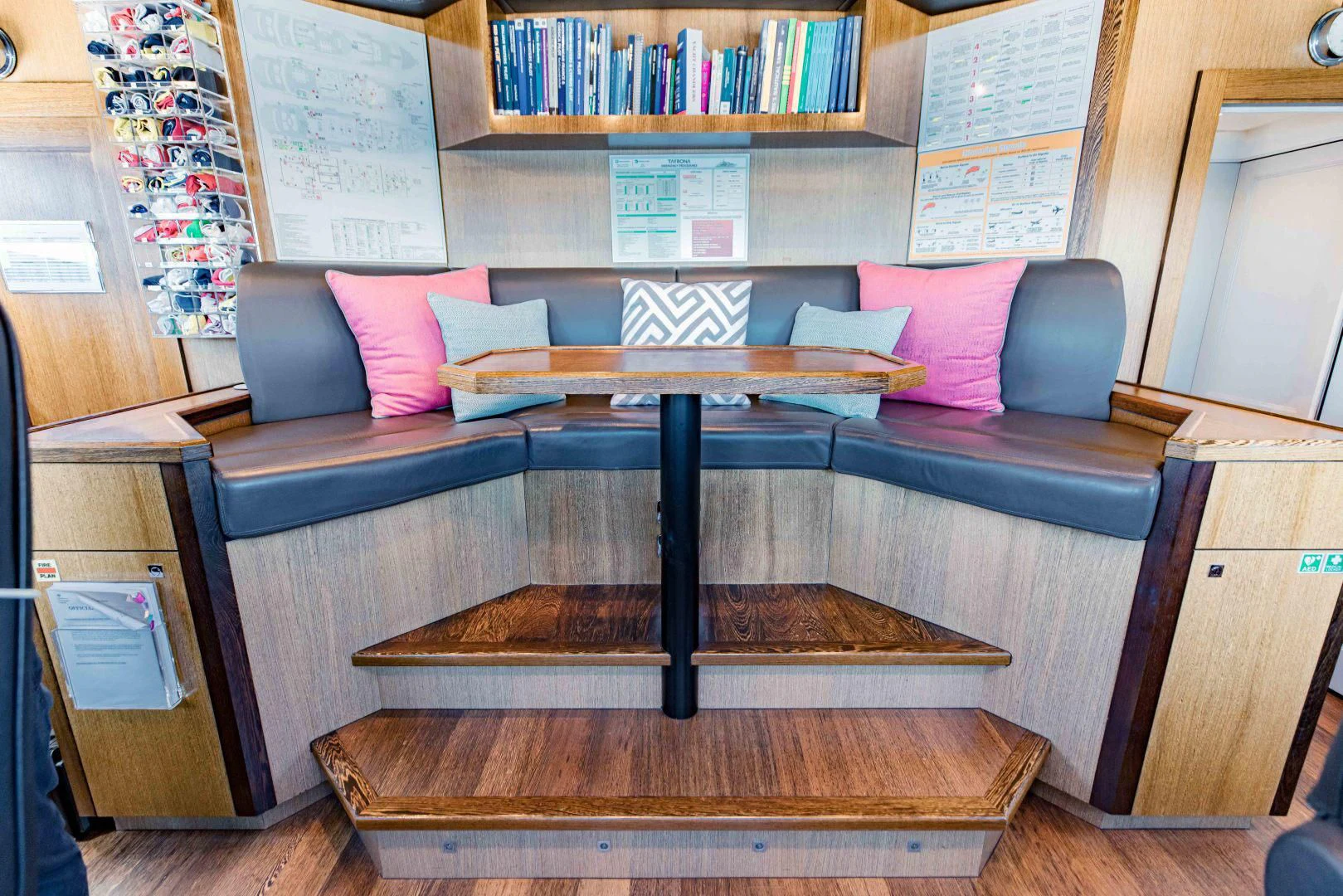 a room with a bench and bookshelf aboard TAYRONA Yacht for Sale