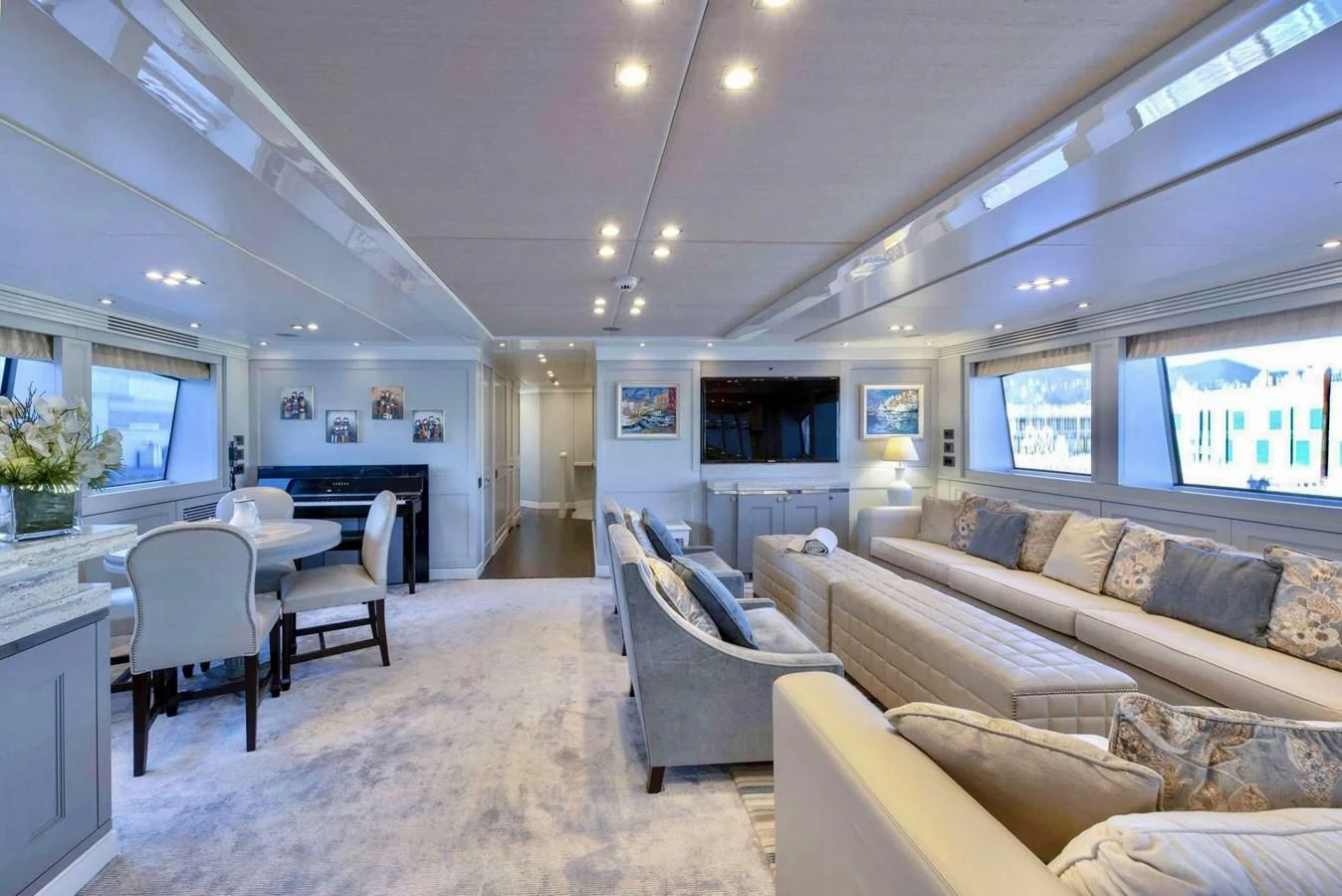 a living room with a couch and a table aboard TAYRONA Yacht for Sale