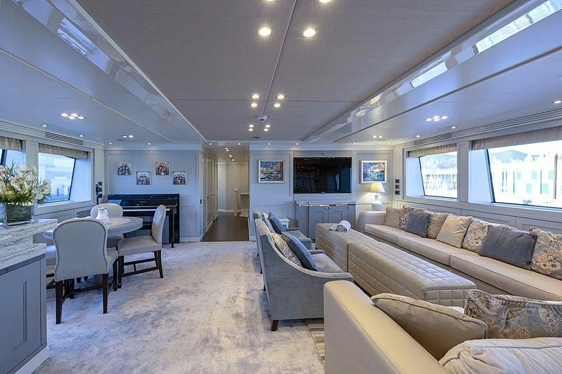 a living room with a couch and a table aboard TAYRONA Yacht for Sale