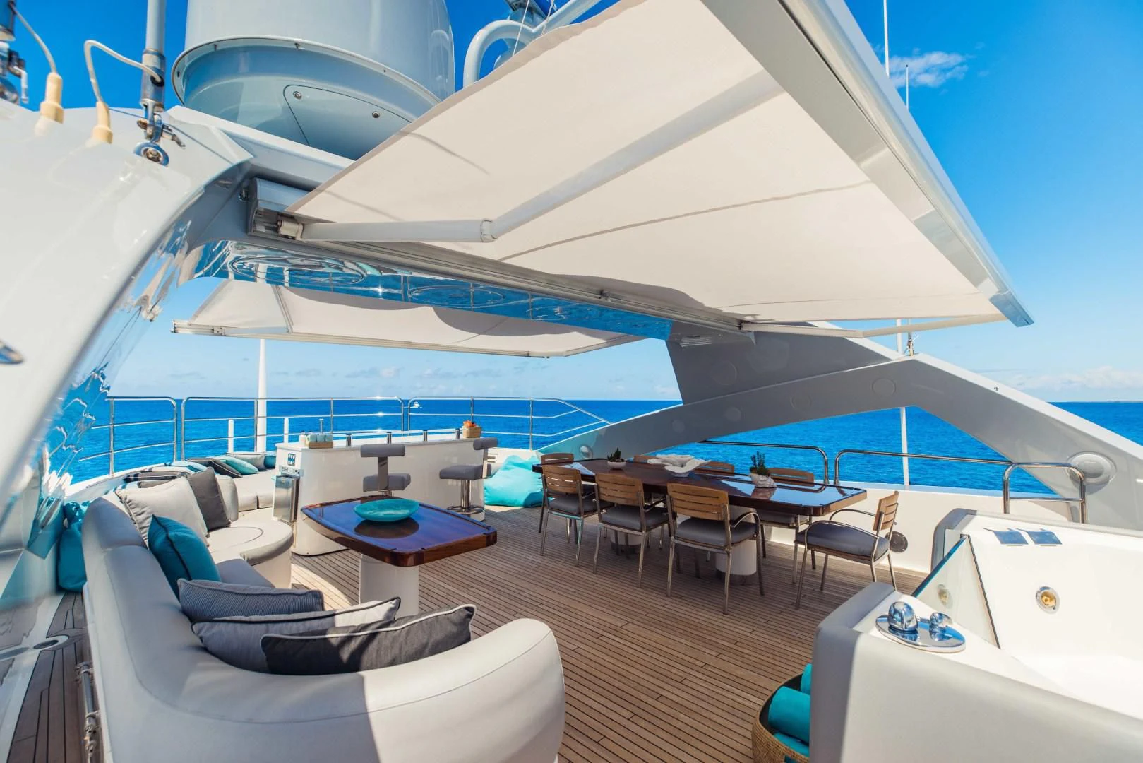 a large white tent with a table and chairs and a pool aboard TAYRONA Yacht for Sale